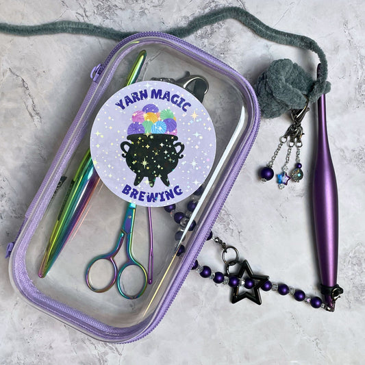 Purple case with knitting tools and 'Yarn Magic Brewing' sticker