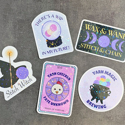 Set of colorful stickers with yarn-themed designs on a gray surface
