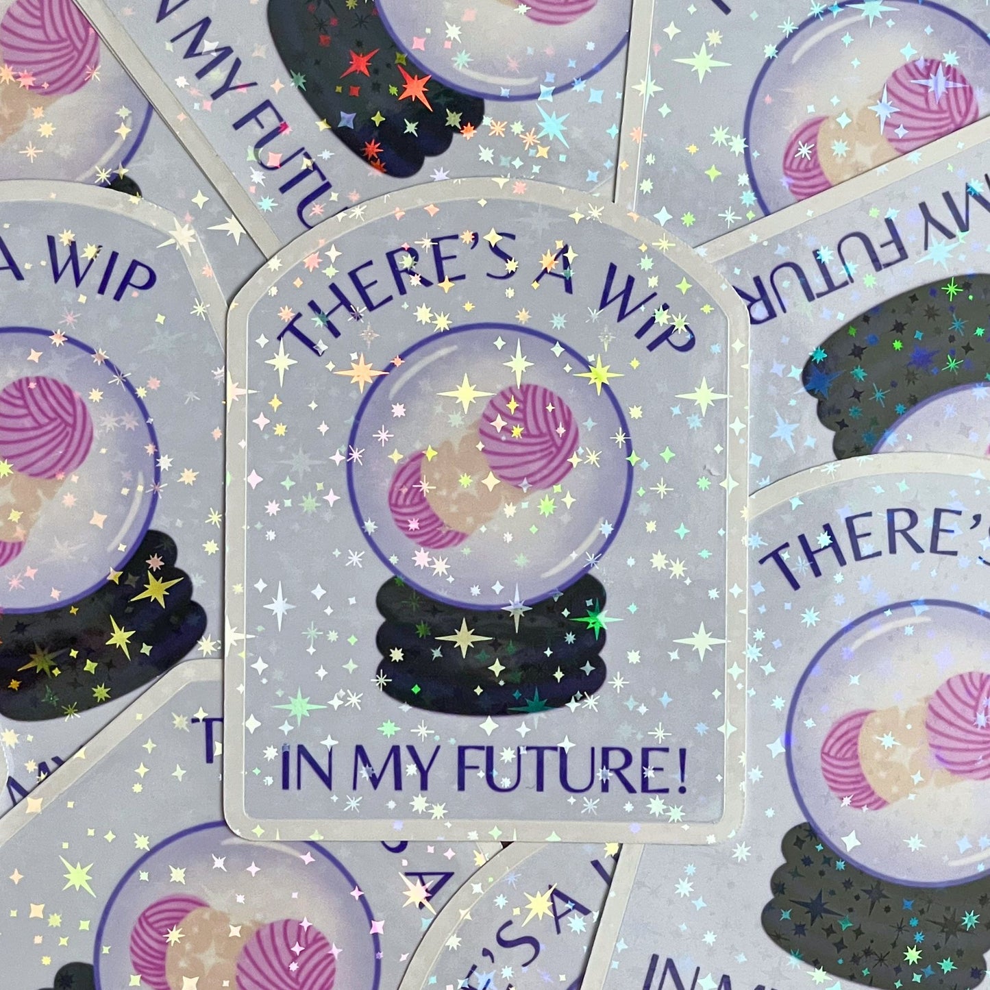 Sticker with 'There's a WIP in my future!' text and yarn ball design on a glittery background.
