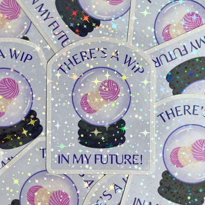 Sticker with 'There's a WIP in my future!' text and yarn ball design on a glittery background.